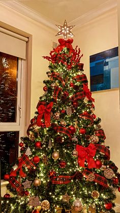 a christmas tree decorated with red and gold ornaments