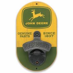 the john deere sign is mounted on a wall with an old fashioned metal hook