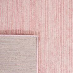 a pink and white striped wallpaper with an area rug