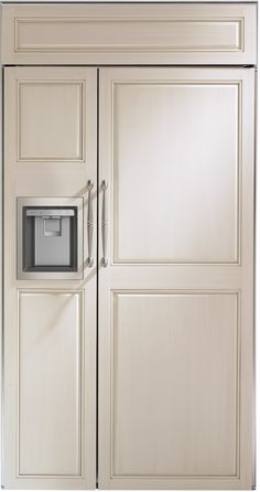 a white refrigerator freezer sitting inside of a wooden kitchen cabinet with an ice dispenser on the door