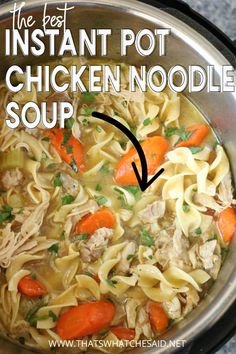 chicken noodle soup with carrots and parsley in a pot on the stove