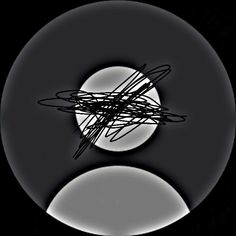 an abstract black and white photo with the moon in the background, as seen through a circular object