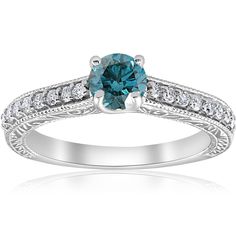 a blue diamond engagement ring with diamonds on the band and side stones in white gold