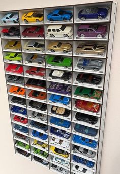 a large display case filled with lots of toy cars on top of each other's sides