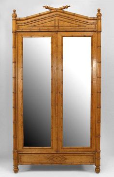 an antique bamboo armoire with mirror