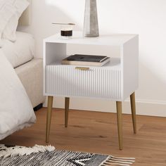 a white nightstand table with a book on top