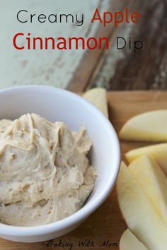 a white bowl filled with cinnamon dip next to sliced apples