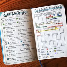 an open planner book sitting on top of a wooden table