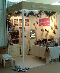 the inside of a shoe store with shoes on display and decorations hanging from the ceiling