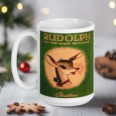 a white coffee mug with rudolph the reindeer on it