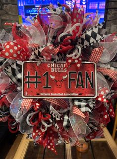 a chicago bulls deco mesh wreath with the number 1 fan on it