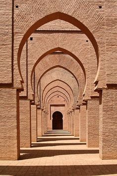 an archway in the middle of a brick building with arches and doorways on either side