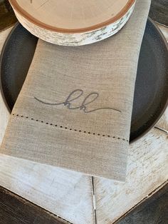 a place setting with linen napkins and wooden plates