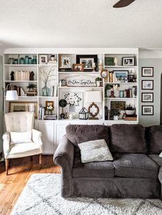 a living room filled with furniture and lots of shelves