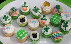 cupcakes decorated with green and white frosting on a plate at a st patrick's day party