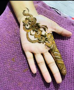 a woman's hand is decorated with hennap and intricate designs on it