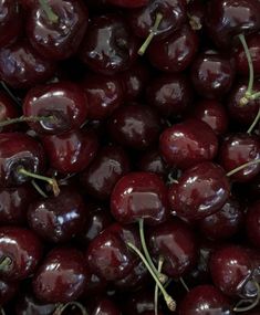 a pile of cherries sitting on top of each other