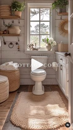 a white toilet sitting in a bathroom next to a window and rug on the floor