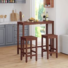 a kitchen table with two stools in front of it