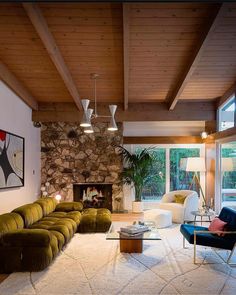 a living room filled with lots of furniture and a fire place next to a window