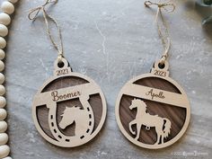 two wooden christmas ornaments with horses on them