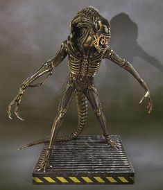 an alien standing on top of a metal platform