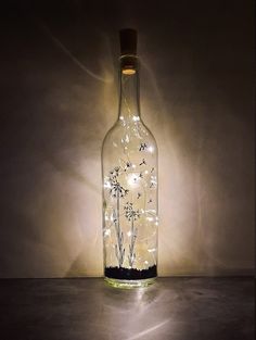 a bottle with lights in it sitting on a table