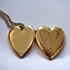 This antique Art Deco heart-shaped locket is crafted with the quality of a bygone era, making it a timeless piece of jewelry for anyone to enjoy. It's the perfect sweetheart gift and a beautiful keepsake of memories that will last a lifetime. This locket and chain with a beautiful art deco engraved front measures about 1 inch across I don't see any stamps or plating wear on this locket I would estimate it to be around 100 yrs old . Heirloom Oval Jewelry For Valentine's Day, Antique Gold Keepsake Pendant Jewelry, Elegant Medallion Locket Necklace For Valentine's Day, Antique Gold Pendant Jewelry For Keepsake, Heirloom Jewelry For Valentine's Day, Double Heart Keepsake Jewelry For Valentine's, Valentine's Day Double Heart Keepsake Jewelry, Valentine's Day Keepsake Double Heart Jewelry, Heart Pendant Locket Necklace For Valentine's Day