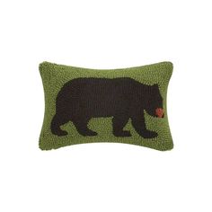 a green pillow with a black bear on it