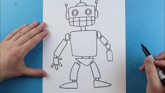 two hands are drawing a robot on paper