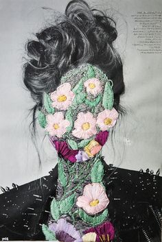 an image of a woman with flowers on her face and in the background is a black dress