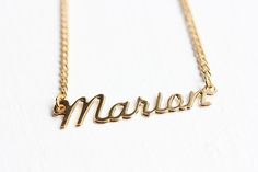 This is a very awesome vintage name necklace. This necklace measures 16" long and the name measures about 1.5" wide total. This is 14k gold plated.Model shown wearing “Marie” name necklace.NOTE: This CAN NOT be custom made. They are vintage, thus you will receive the exact same name in the photo above. We have lots of vintage name jewelry in the shop! You can see them all here at this link:https://www.etsy.com/shop/diamentdesigns/search?search_query=name&order=date_desc&view_type=gallery&ref=sho Vintage Silver Name Necklace, Vintage Personalized Nameplate Necklace, Personalized Vintage Nameplate Necklace, Vintage Custom Name Jewelry Nameplate, Vintage Nameplate Necklaces, Vintage Custom Nameplate Jewelry, Vintage Custom Name Nameplate Jewelry, Vintage Gold Name Necklace, Vintage Gold Necklace With Name Detail