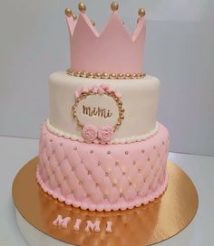 a pink and white cake with a crown on top