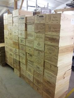 several stacks of wooden boxes stacked on top of each other in a warehouse or workshop