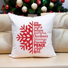 a christmas tree pillow sitting on top of a couch