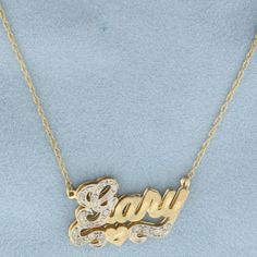 In 14k yellow gold. Contains fifteen high quality 1/2pt diamonds. 19 inch long and 1.1 inch wide chain, spring clasp. Nameplate is 1 inch by 5/8 inch. 3.9g.   Inventory 20540 Yellow Gold Nameplate Jewelry With Diamond Accents, Gold Name Necklace With Diamond Accents, 14k White Gold Name Necklace With Diamond Accents, Formal Yellow Gold Name Necklace With Diamond, Formal Yellow Gold Diamond Name Necklace, Gold Nameplate Necklace With Diamond Accents, Fine Jewelry Yellow Gold Name Necklace With Diamonds, Fine Jewelry Yellow Gold Diamond Name Necklace, Fine Jewelry Diamond Name Necklace In Yellow Gold