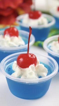 small cups filled with whipped cream and cherries