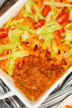 a large casserole dish with lettuce and tomatoes