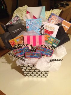 a gift basket filled with lots of different types of cards and gifts on top of a table