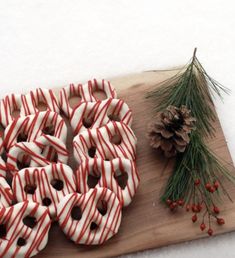 there are many donuts that have been decorated with candy canes and pine cones