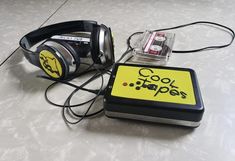 a pair of headphones sitting on top of a table next to an mp3 player