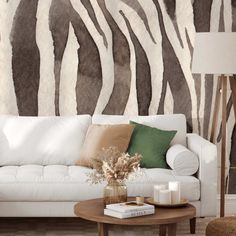 a living room with a white couch and zebra print wallpaper