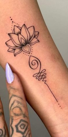 a woman's foot with a lotus tattoo on it