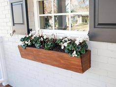 a window box filled with flowers on the side of a building