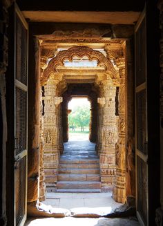 an archway leading into a building with carved pillars