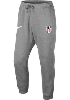 Get cozy in these Team USA Grey Club Sweatpants! Whether you're relaxing watching the game or just out running errands, these Team USA Shop Sweats are the perfect way to show your Team USA spirit in comfort and style. These Team USA Sweatpants also feature a fleece material with an elastic drawstring waistband, ankle cuffs and team graphics on the left hip. Classic jogger silhouette, Brushed-back fleece, Tapered leg and rib cuff for comfortable fit, Side seam pockets, Back snap pocket, Fold over Nike Cotton Pants With Moisture-wicking, Gray Sports Pants With Ribbed Cuffs, Nike Fleece Activewear For Sports Events, Sportswear Sweatpants For Sports Events, Nike Cotton Sweatpants For Sports Season, Sporty Cotton Joggers For Sports Events, Nike Cotton Sweatpants, Cotton Athleisure Pants For Sports Events, Sportswear Joggers For Sports Events And Season