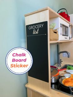 a kitchen with a chalk board on the wall