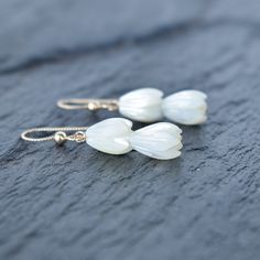 Beautiful hand carved Mother of Pearl Pikake bead earrings. These Pikake are not plastic, they are real mother of pearl. These Pikake earrings are so dainty and versatile, they go with everything! Your choice of sterling silver or gold fill - they will not tarnish and can even get wet. White Carved Earrings For Gift, Adjustable White Mother Of Pearl Earrings, Cluster Earrings, Bead Earrings, Beautiful Hand, Jewelry Ideas, Beaded Earrings, Mother Of Pearl, Jewelry Earrings Dangle