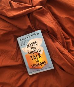 the book maybe you should talk to someone by lori gottlich is laying on an orange sheet