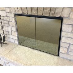 a mirror sitting on top of a stone fireplace